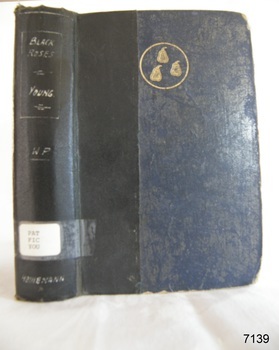 A blue hard cover with a black stripe, a golden emblem, book's name on the spine in white font