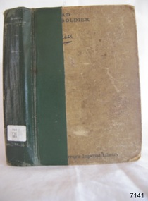 A brown spotted cover with green tape applied to the spine. Title and text is white and black font