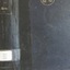 A blue hard cover with a black stripe, a golden emblem, book's name on the spine in white font