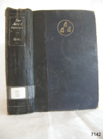 A blue hard cover with a black stripe, a golden emblem, book's name on the spine in white font