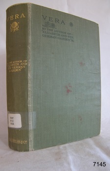A large book with a green hard cover with gold writing 
