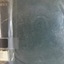 A large book with a green hard cover and a clear dust jacket