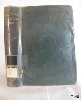 A large book with a green hard cover and a clear dust jacket