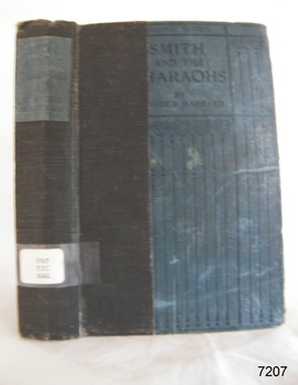 Blue hardcover book with reinforced spine, black print on spine and cover, label on spine