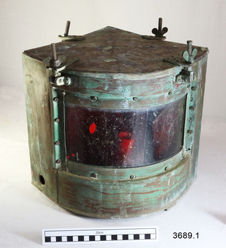 Metal quadrant shaped lamp with red glass on the curve