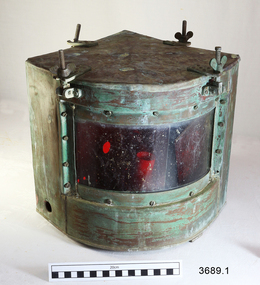 Metal quadrant shaped lamp with red glass on the curve