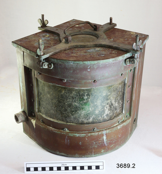Metal quadrant shaped lamp with green glass on the curve