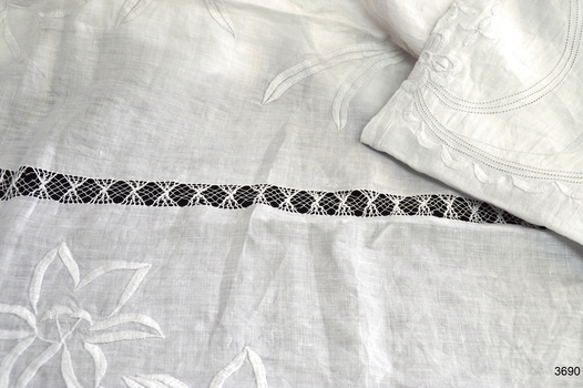 Floral embroidered motif and gathered tread edging
