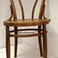 Cane chair has a round bentwood back and bentwood legs stabilised by a strengthening ring inside the legs.