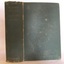 Textured green hardcovered book with gold embossed title on spine