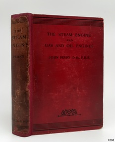 Red hard covered book with black text and decoration on the cover and spine