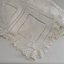White crochet bedspread with worked squares and lace-like edging