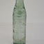 Clear bottle with marble seal, upright, glass has slight green tinge. Embossed text is clear.