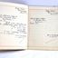 Printed and ruled lines on pages with handwritten script notes and correction ticks