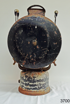 Back of lamp is a round shaped piece of metal