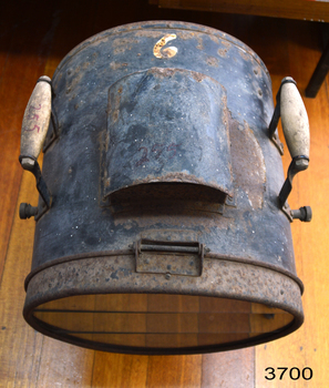 Metal cylinder of lamp top showing flue and hinge