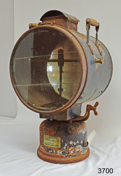 Metal cylinder with glass front mounted on a round fuel tank