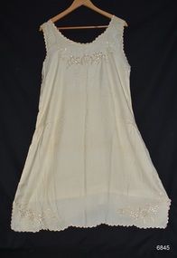 Sleeveless cream silk petticoat with embroidered design on bodice