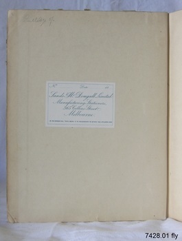 White label with blue print is attached. There is a handwritten inscription