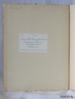 White label with blue print is attached. There is a handwritten inscription