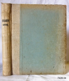 Beige hard covered diary with title printed on spine