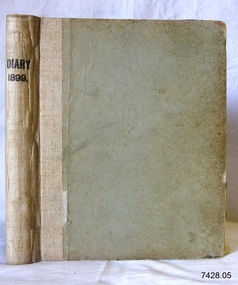 Beige coloured hardcovered book with printed title on spine