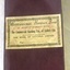 Maroon covered book with cream coloured label pasted on the front, printed and hand written details on label.