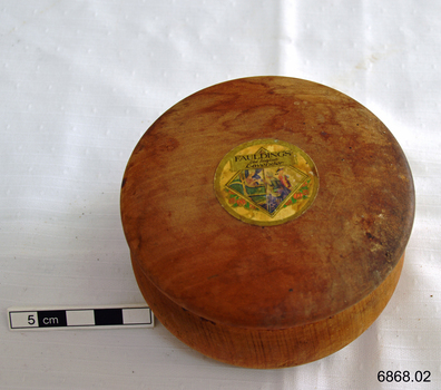 Round wooden box with lid, originally containing lavender soap or powder.