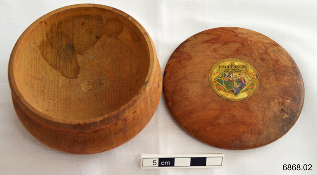 Round wooden box with lid, originally containing lavender soap or powder.