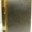 Upright book with textured hard cover and labels on the spine