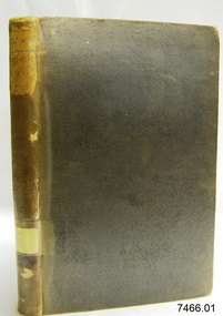 Upright book with textured hard cover and labels on the spine