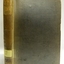 Upright book with textured hard cover and labels on the spine
