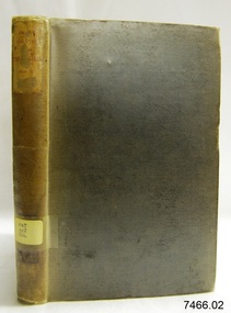 Upright book with textured hard cover and labels on the spine