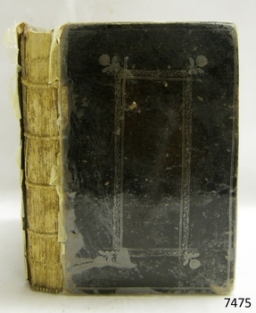 Black hardcover book with embossed border on front cover, spine not covered