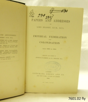 Fly page has black text, black handwritten inscriptions and oval stamp