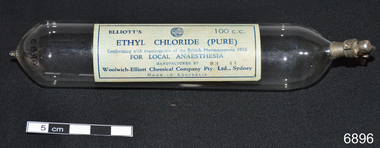 Glass medication ampoule once containing ethyl chloride for local anaesthesia. Has metal spring release device to administer the gas.