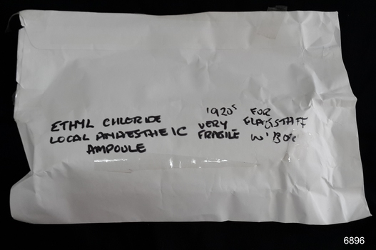 Glass medication ampoule once containing ethyl chloride for local anaesthesia. Has metal spring release device to administer the gas.