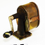 A metal desk pencil sharpener, with handle at rear, and aperture at front. Badly rusted.