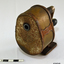A metal desk pencil sharpener, with handle at rear, and aperture at front. Badly rusted.