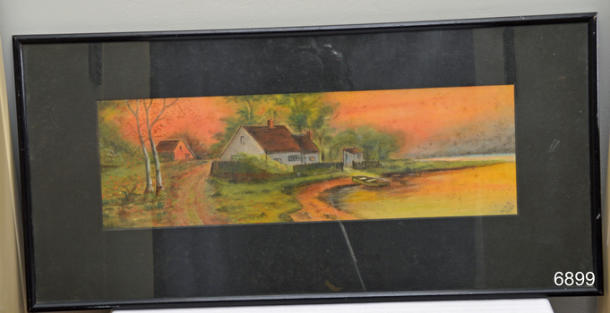 Landscape view of cottage beside lake, framed and behind glass