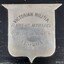 Silver shield with engraved text explaining the awarded and its donor