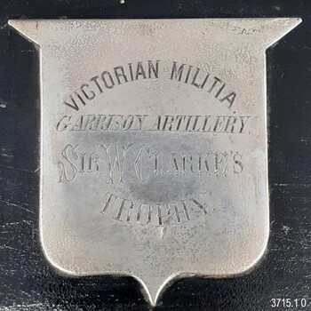 Silver shield with engraved text explaining the awarded and its donor
