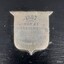 Silver shield with engraved text announcing the winner