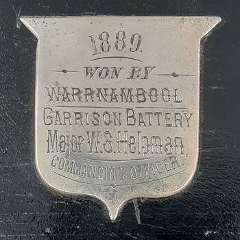 Silver shield on the trophy's black plinth