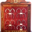 Glass fronted, timber framed case lined with red fabric. Contains horse shoes