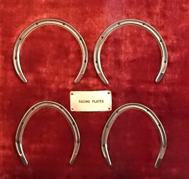 Two pairs of racing plates, horseshoes