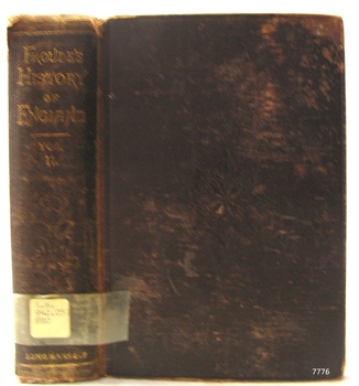 Brown fabric hardcover book with embossed gold test on spine