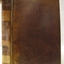Brown textured hardcover with text and label on the spine