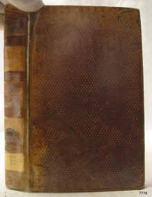 Brown textured hardcover with text and label on the spine