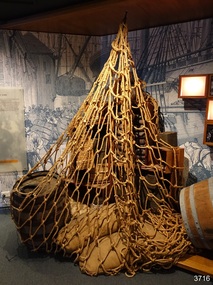 Net made from knotted rope opened out and enclosing cargo